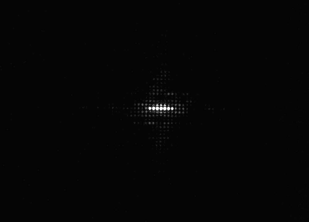 A point of light diffracted through a T‑OLED display