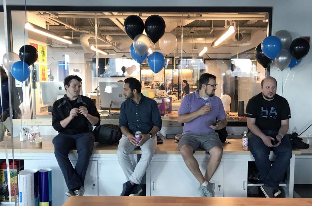 Project team photo, casual talking in Garage Maker space